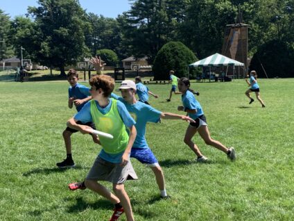 campers playing frisbee.