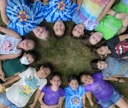 campers laying down in a circle.