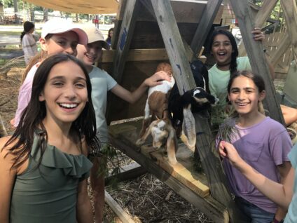 campers posing with goats.