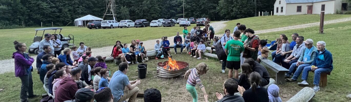 campers gathered around a fire.